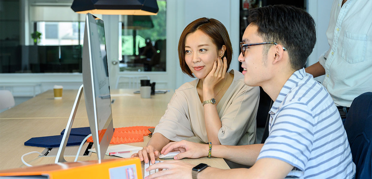 Man and Woman Looking at Computer